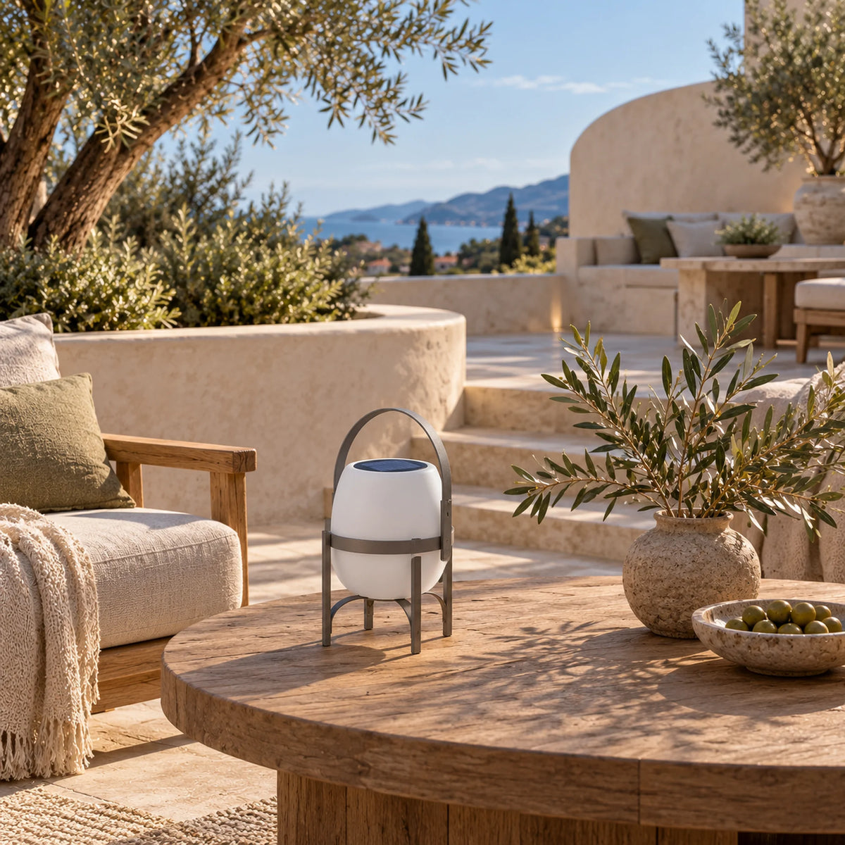 Ovella solar lantern on a weathered timber table beside garden seating.