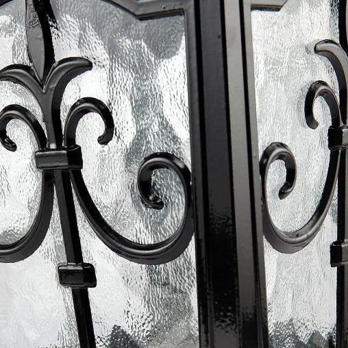 Macro of the iron scrollwork against the textured glass panel