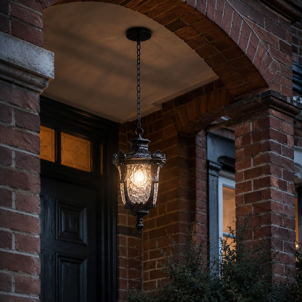 Hammered glass pendant lantern hung in a brick archway above a dark front door