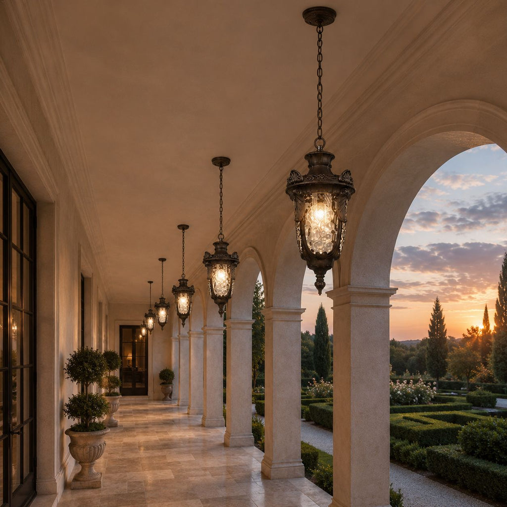 Hammered glass pendant lanterns in a white arched loggia at sunset