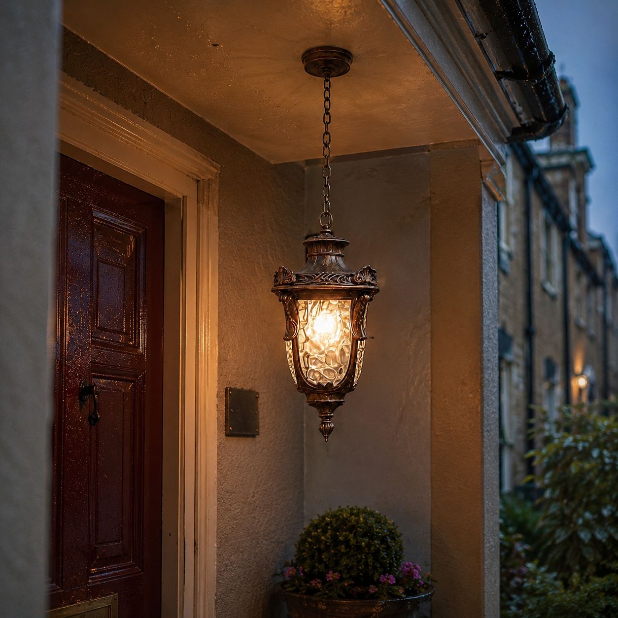 Hammered glass pendant lantern beside a dark timber door on a stone facade
