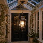 Hammered glass pendant lantern in a glass-roofed porch above a front door
