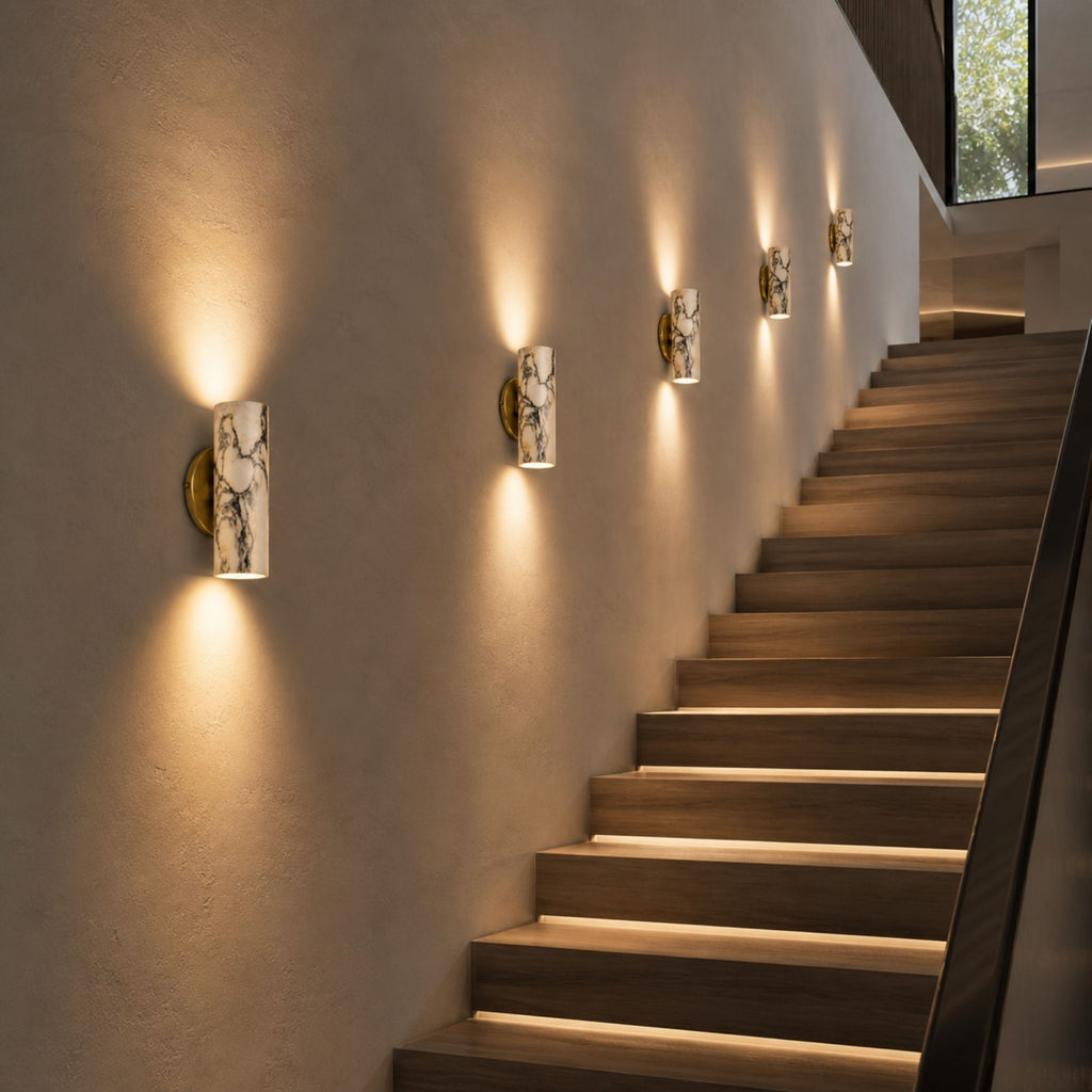 Marble wall lamps along staircase wall with warm ambient architectural lighting