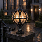 Black globe post light in heavy rain, water running over the glass globe and cast frame