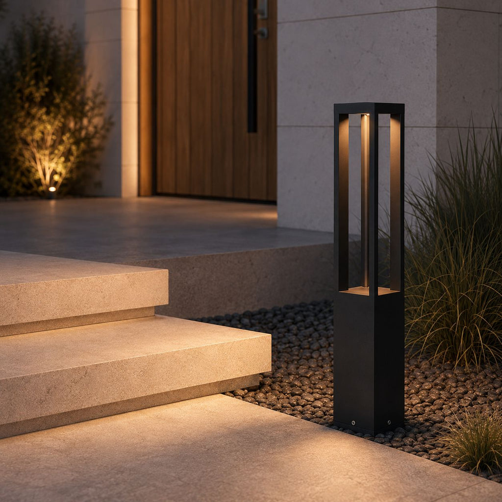 LED bollard light beside stone steps leading to a timber entrance, gravel bed