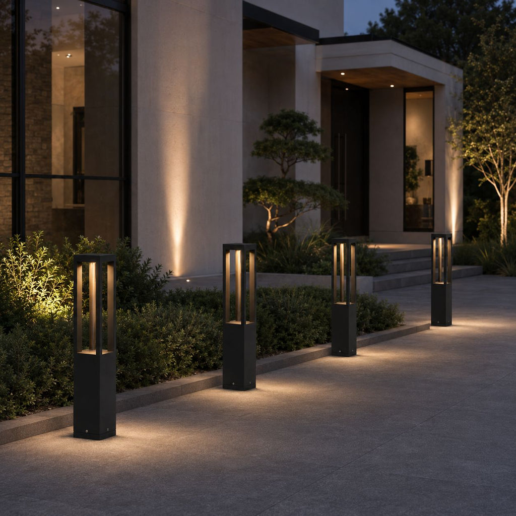 Pair of LED bollard lights flanking the entrance of a modern house at dusk