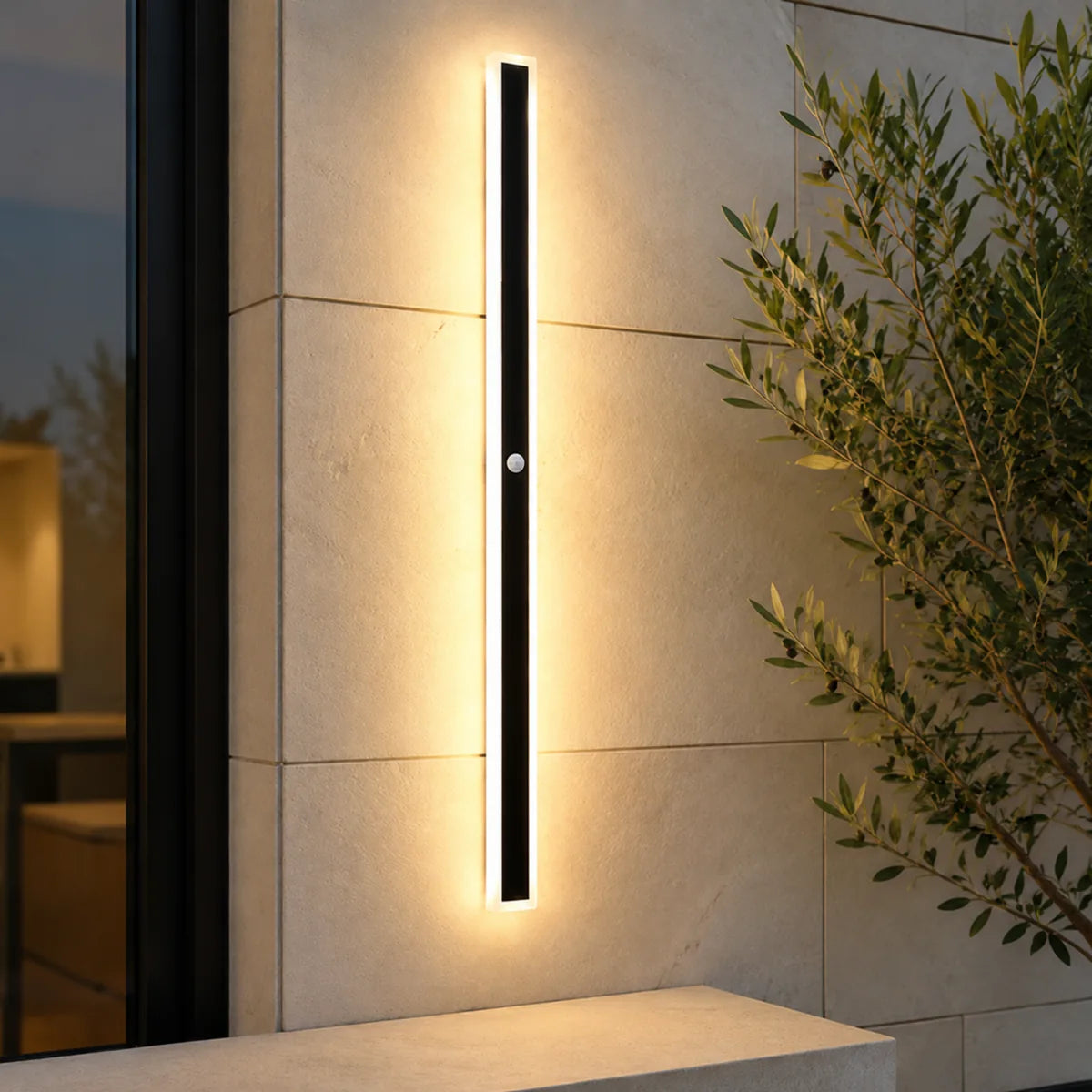 AquaLuxe warm white motion sensor wall light beside an olive tree on a patio