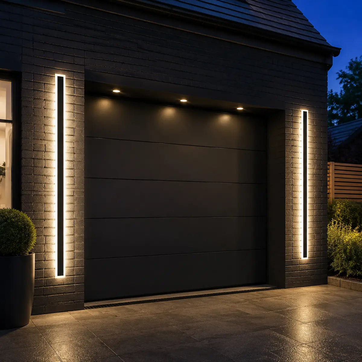 Two AquaLuxe warm white steady wall lights beside a garage
