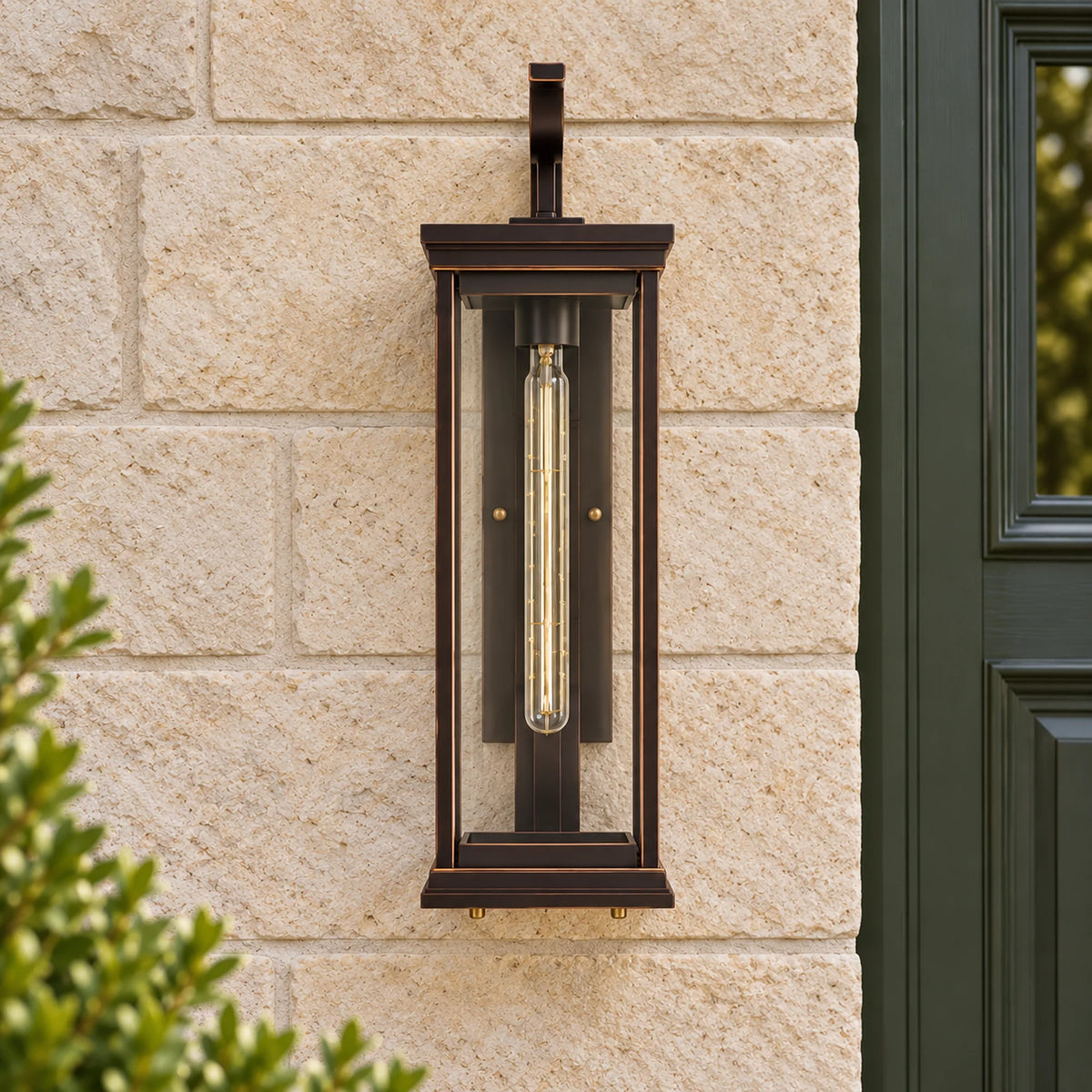 Unlit front view of the BronzeAura coffee-bronze wall lantern with clear glass, mounted on limestone.