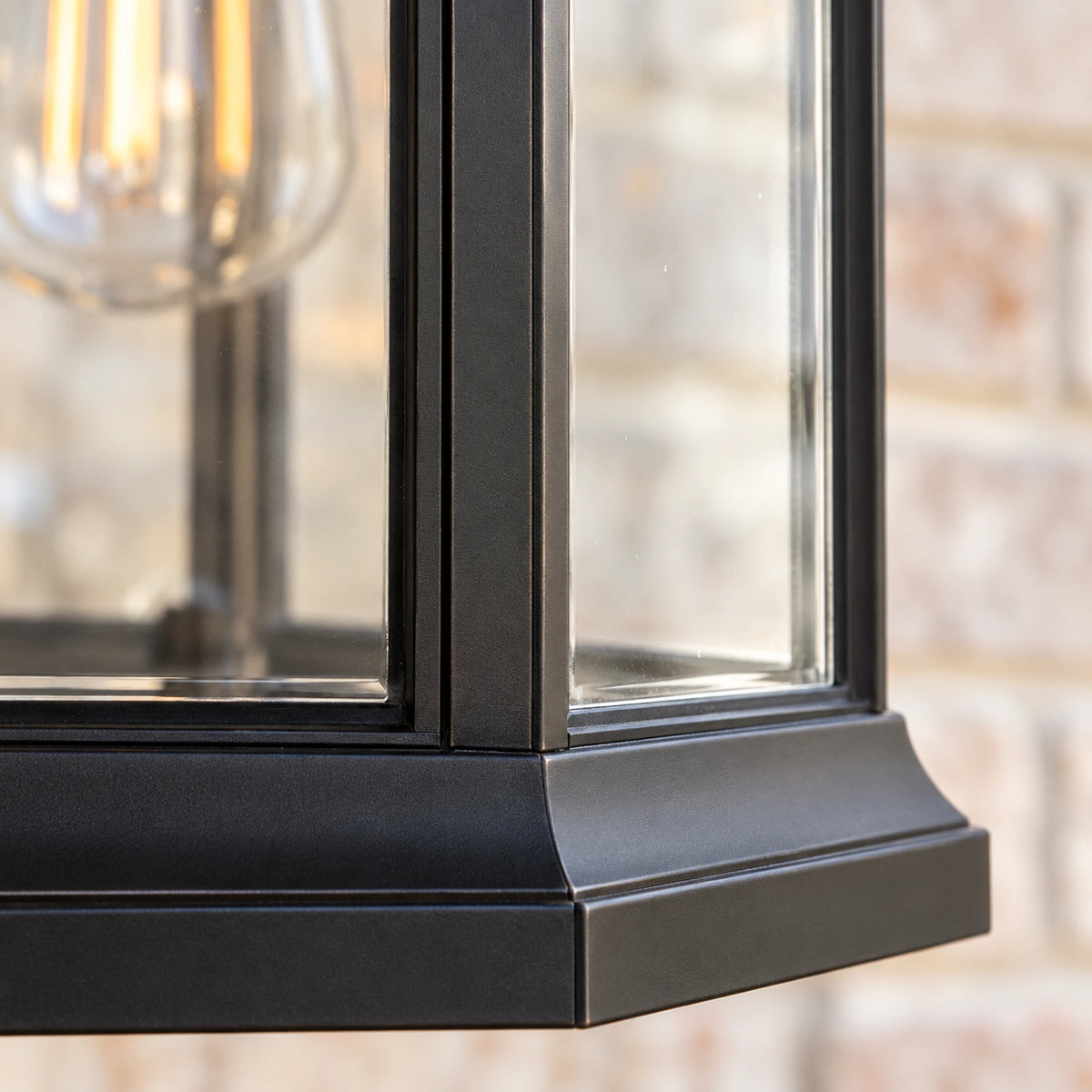 Close-up of Portiva clear glass panes, black metal frame junction and stepped lower rim.