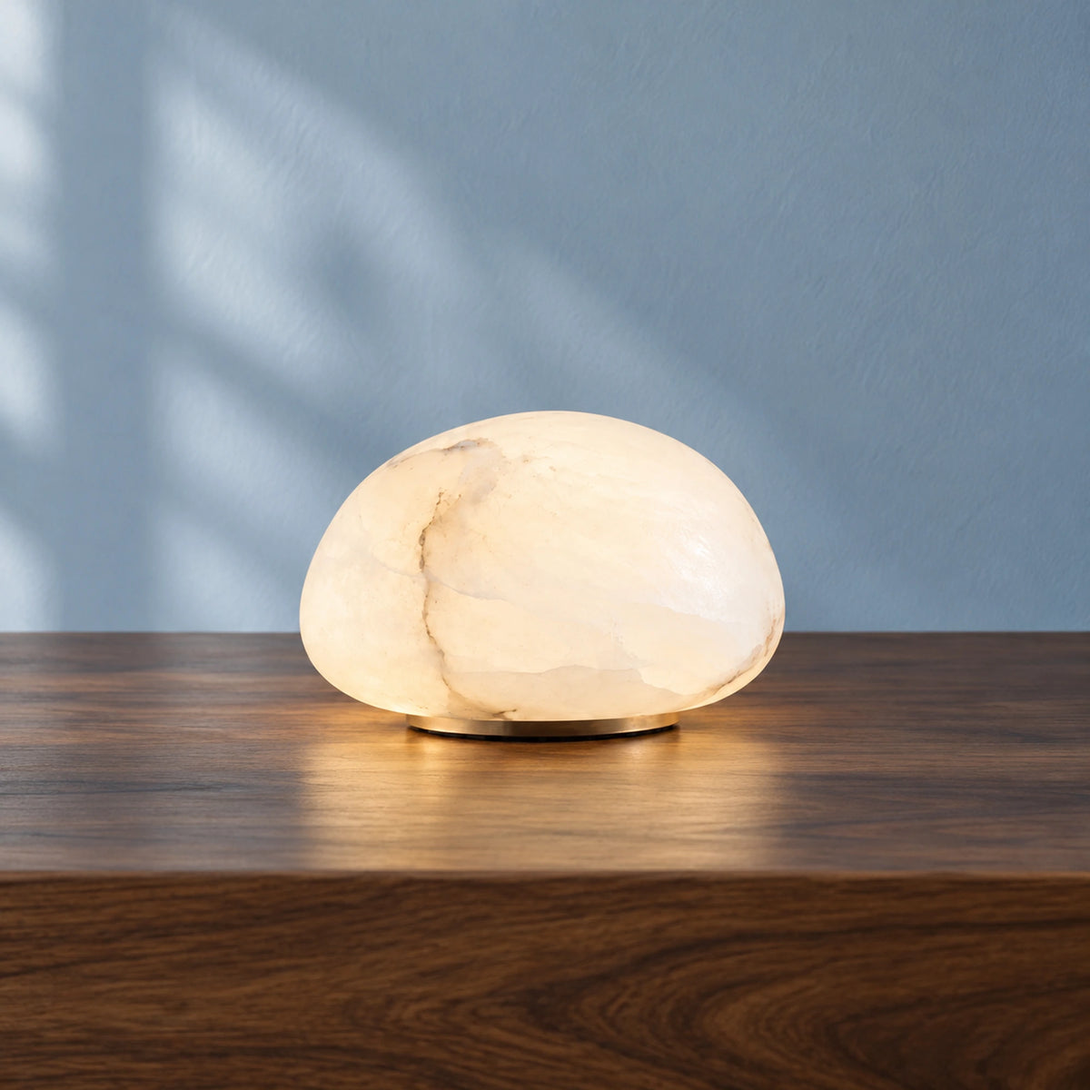 Small Nivelle alabaster pebble lamp with White illumination, front view.