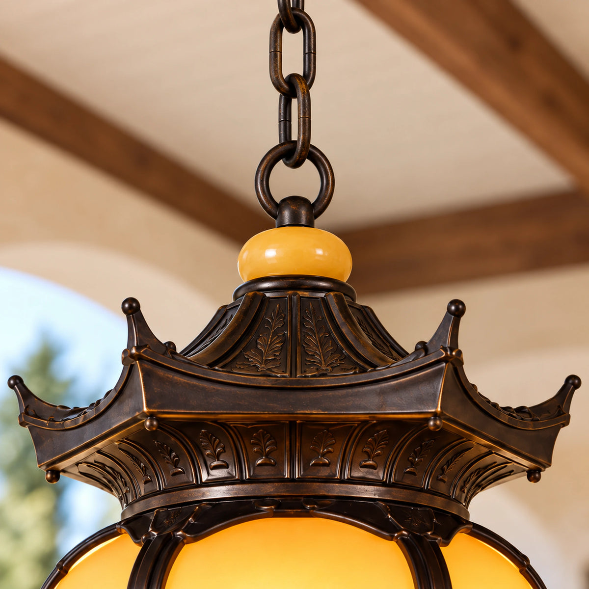 Pavilora interlinked chain, attachment ring, amber bead and upturned pagoda roof shown close up.
