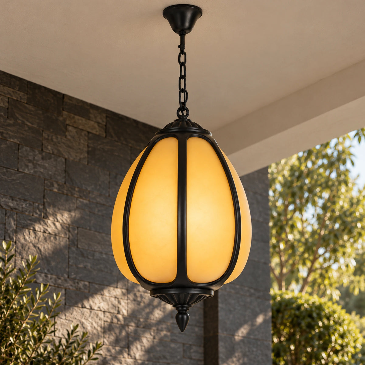 Petalora Large pendant illuminated beneath a covered ceiling, viewed slightly from below to show the fluted underside and finial.