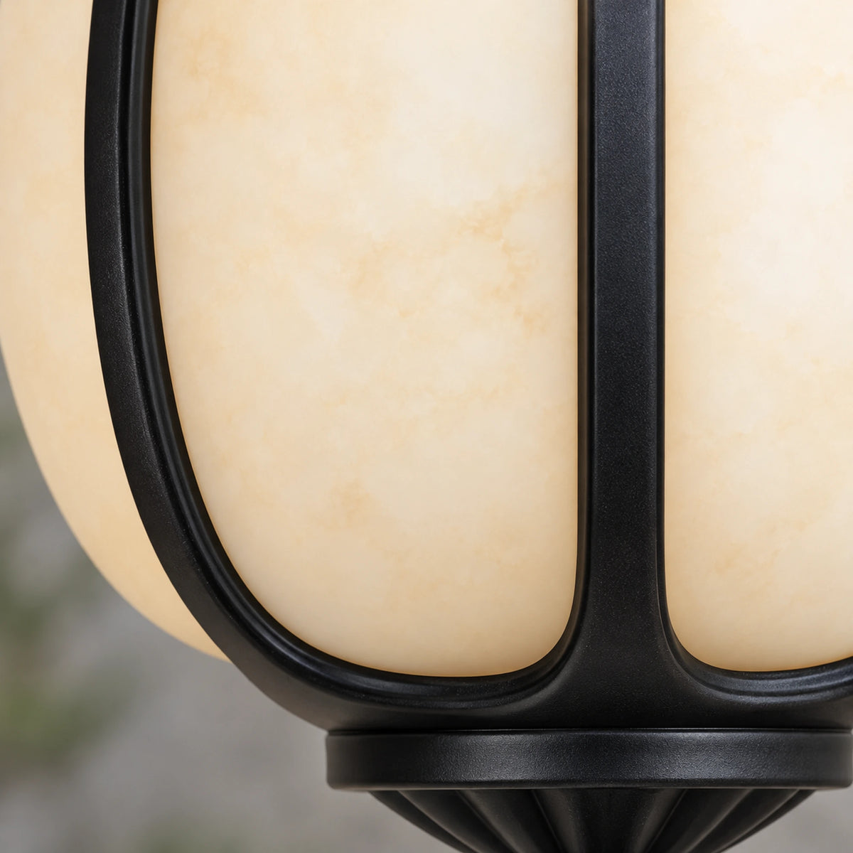 Close-up of Petalora’s cream faux alabaster panels meeting curved sandblasted black ribs and the lower collar.