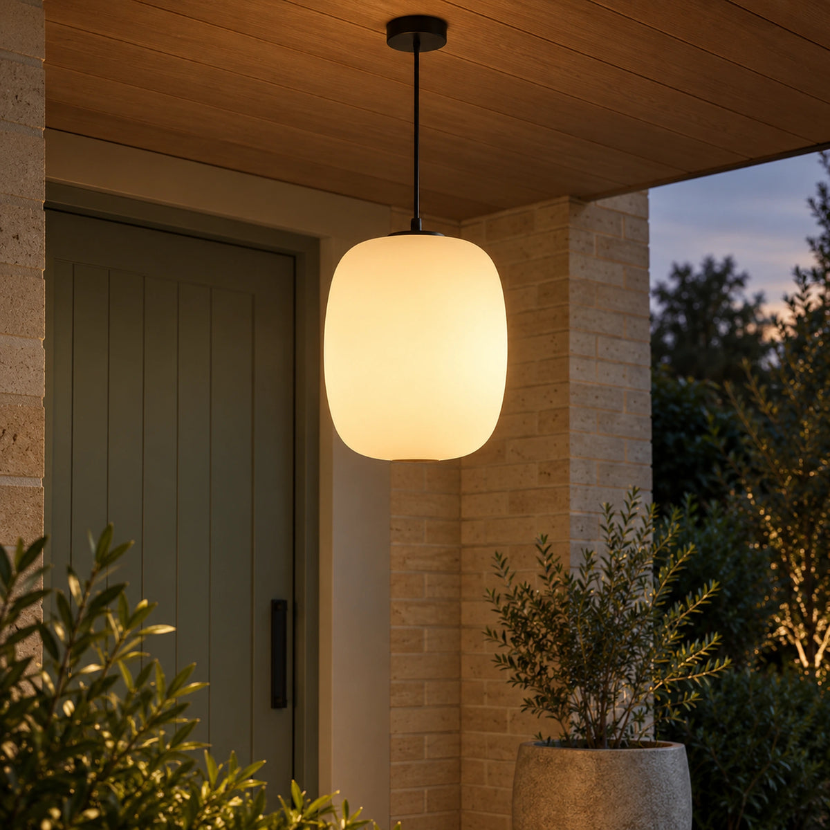 Shizora pendant glowing beneath a timber porch ceiling beside a sage-green entrance door.