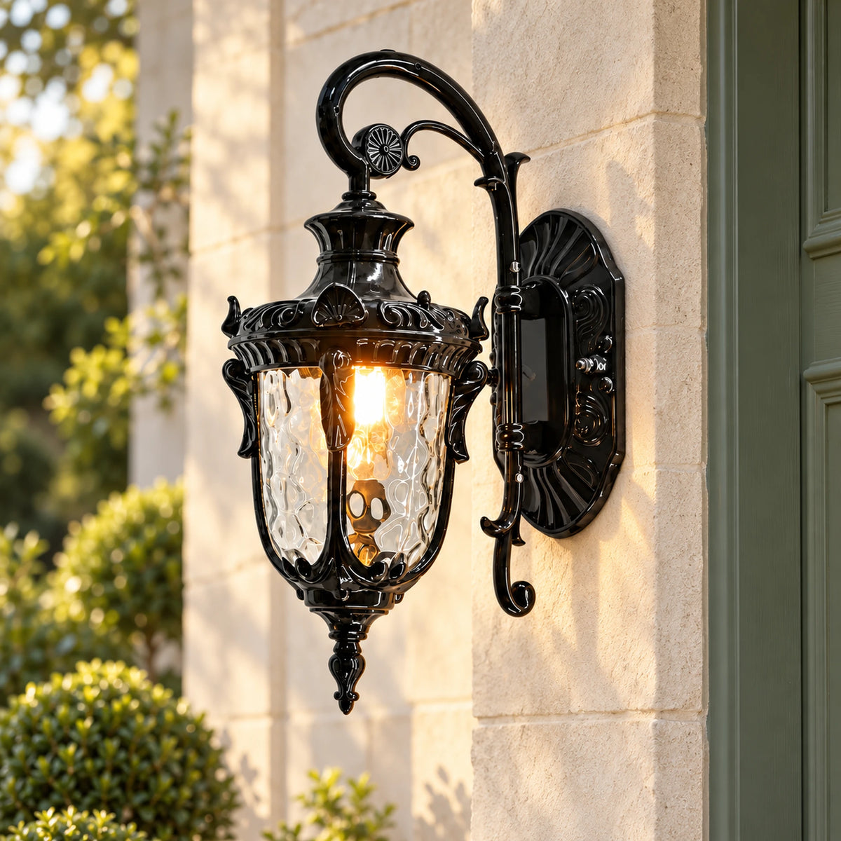 Flutera black wall lantern with a curved arm, ornate backplate and illuminated textured glass on a pale exterior wall.