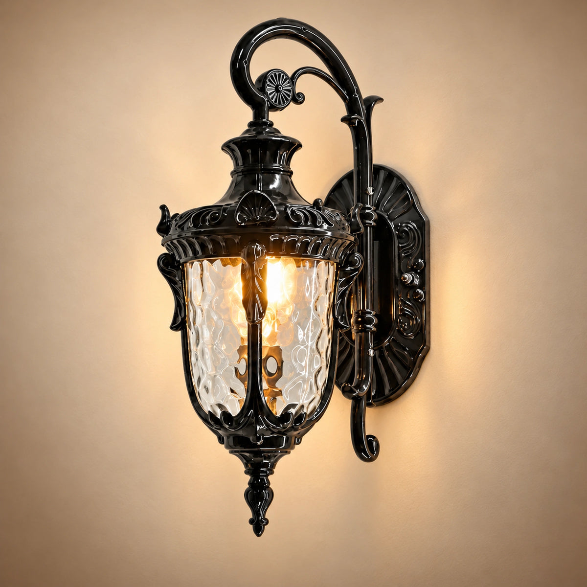 Flutera black wall lantern showing its upper scroll, decorative backplate and illuminated textured-glass shade.