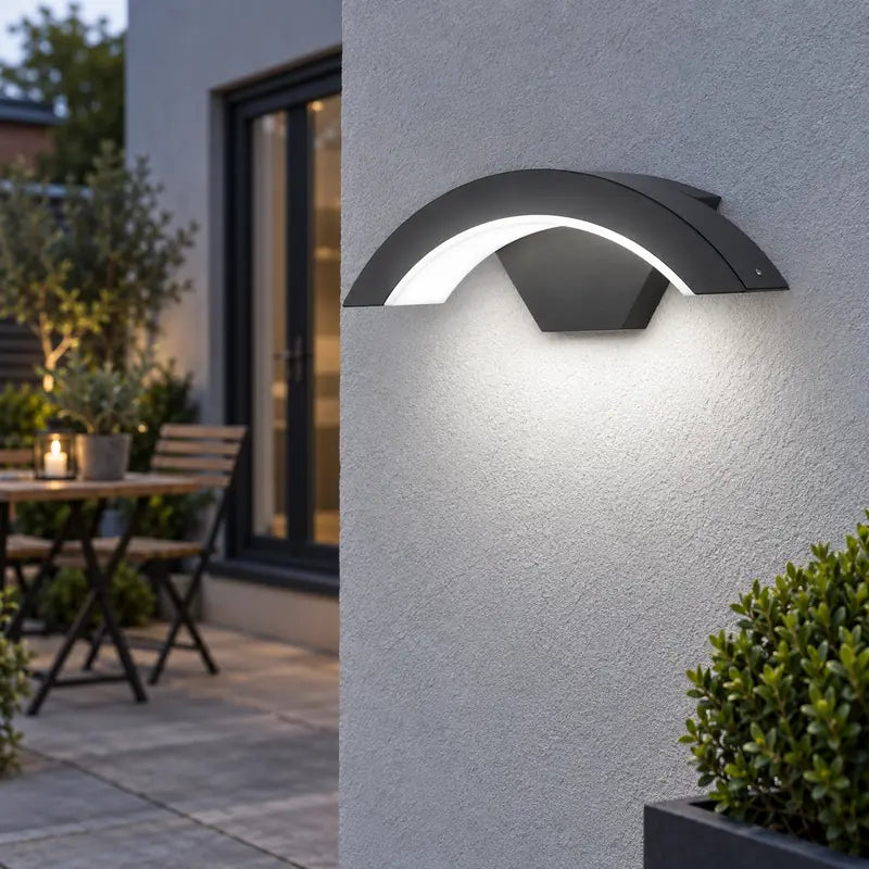 Luminara 18W White Light curved black wall sconce on a patio wall