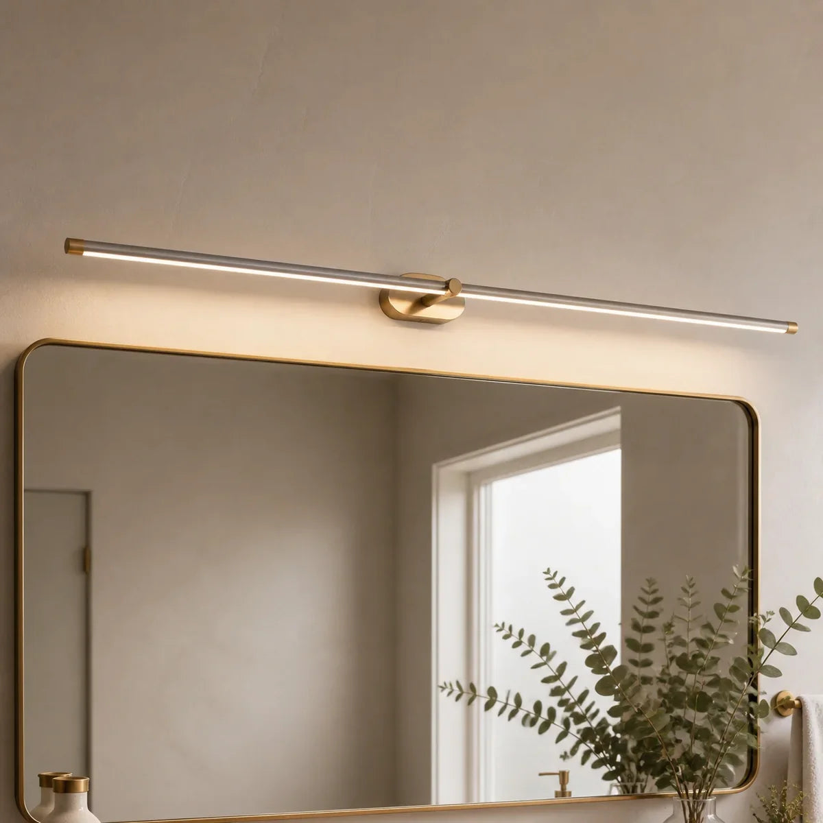 Luminara 50 inch Brushed Nickel and Gold mirror light in a bathroom