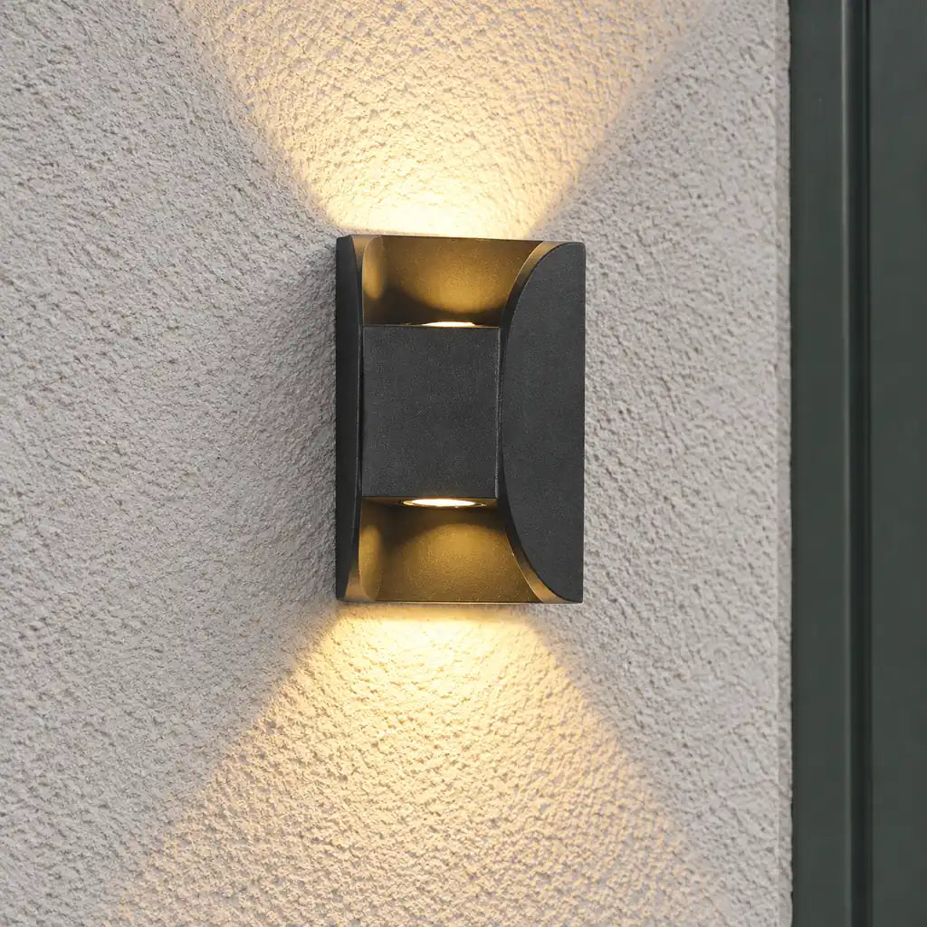 Luminara 12cm black outdoor wall light with illuminated upper and lower cavities