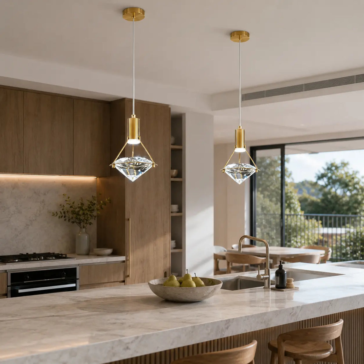 Two Luminara adjustable crystal pendant lights above a bright kitchen island