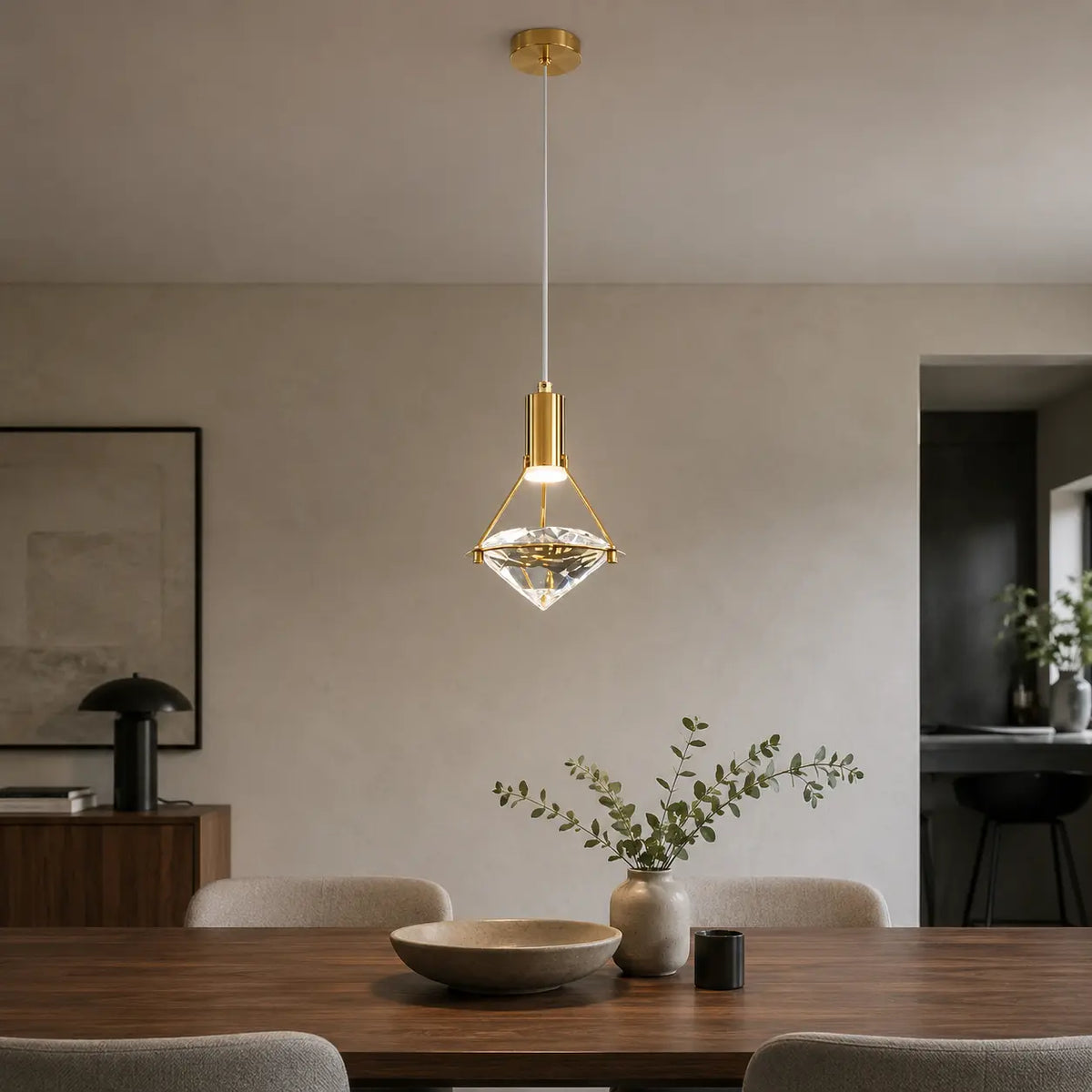 Luminara adjustable crystal pendant light above a refined modern kitchen counter