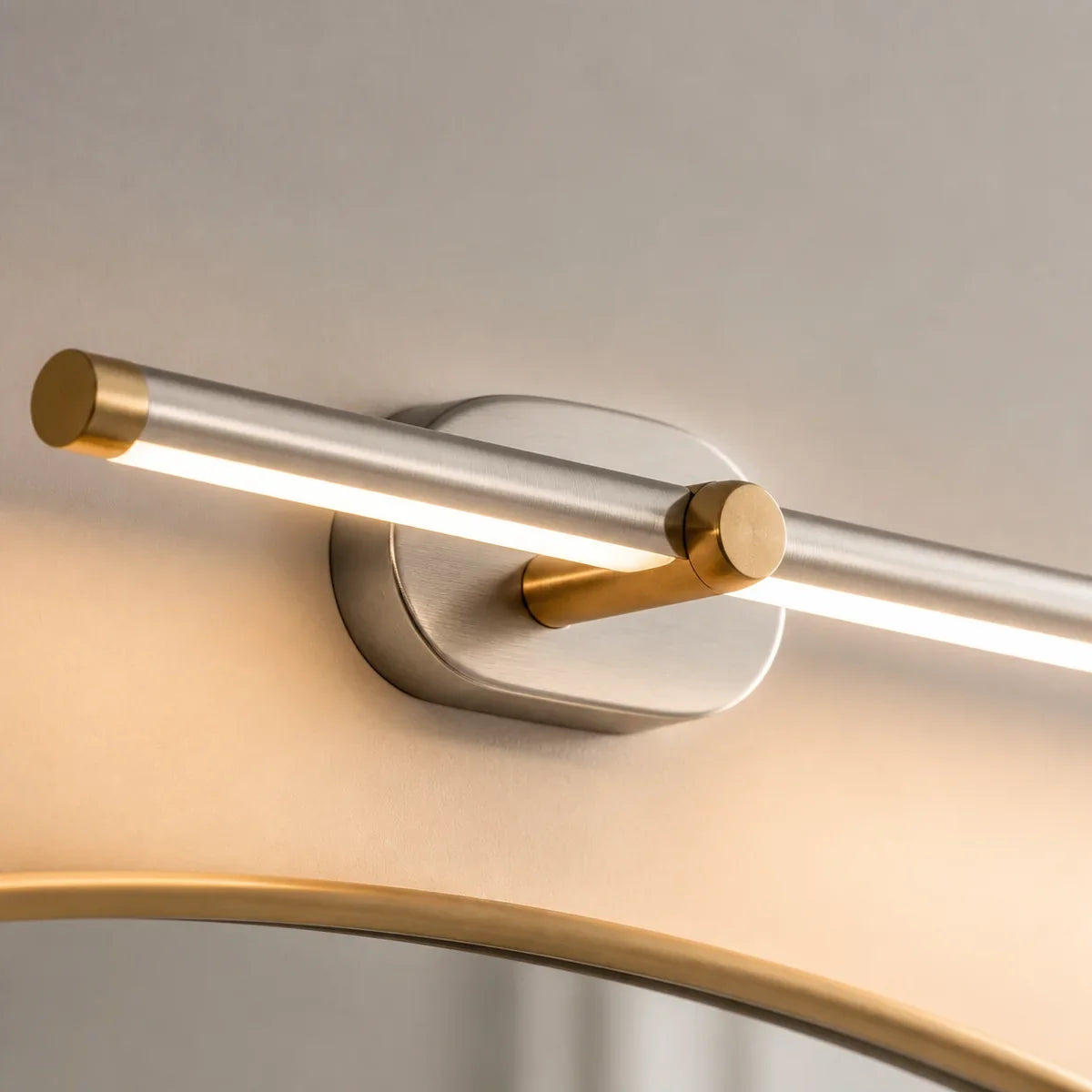 Close detail of Luminara Brushed Nickel and Gold mirror light wall mount and diffuser